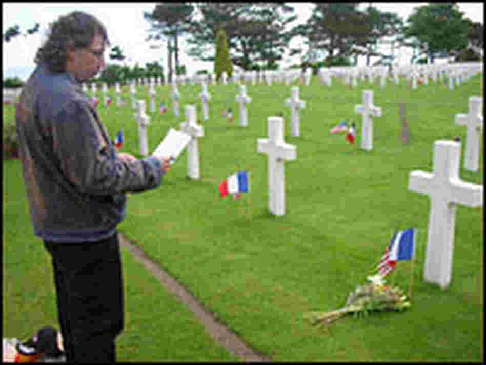 Jean Michel Miette pays his respects at Walter Malcolm's grave in an American cemetery.