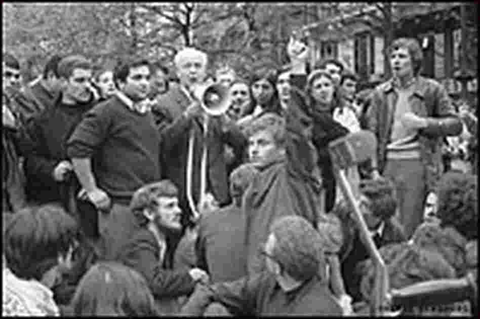 Louis Aragon talks to students on a megaphone.