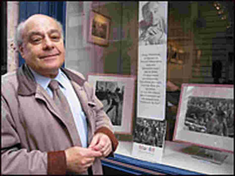 Photographer Serge Hambourg stands next to exhibit