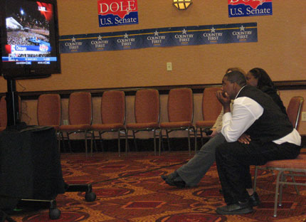 African-American hotel employees watch Obama's victory speech