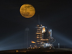 The moon rises behind the Space Shuttle Endeavour as it sits on the launch pad, Nov. 14, 2008, at the Kennedy Space Center in Cape Canaveral, Fla. Credit: Bill Ingalls/NASA/Getty Images