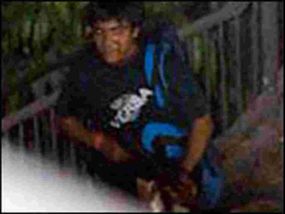 A suspected terrorist is seen with a rifle outside the Chhatrapati Shivaji Terminal railway station.