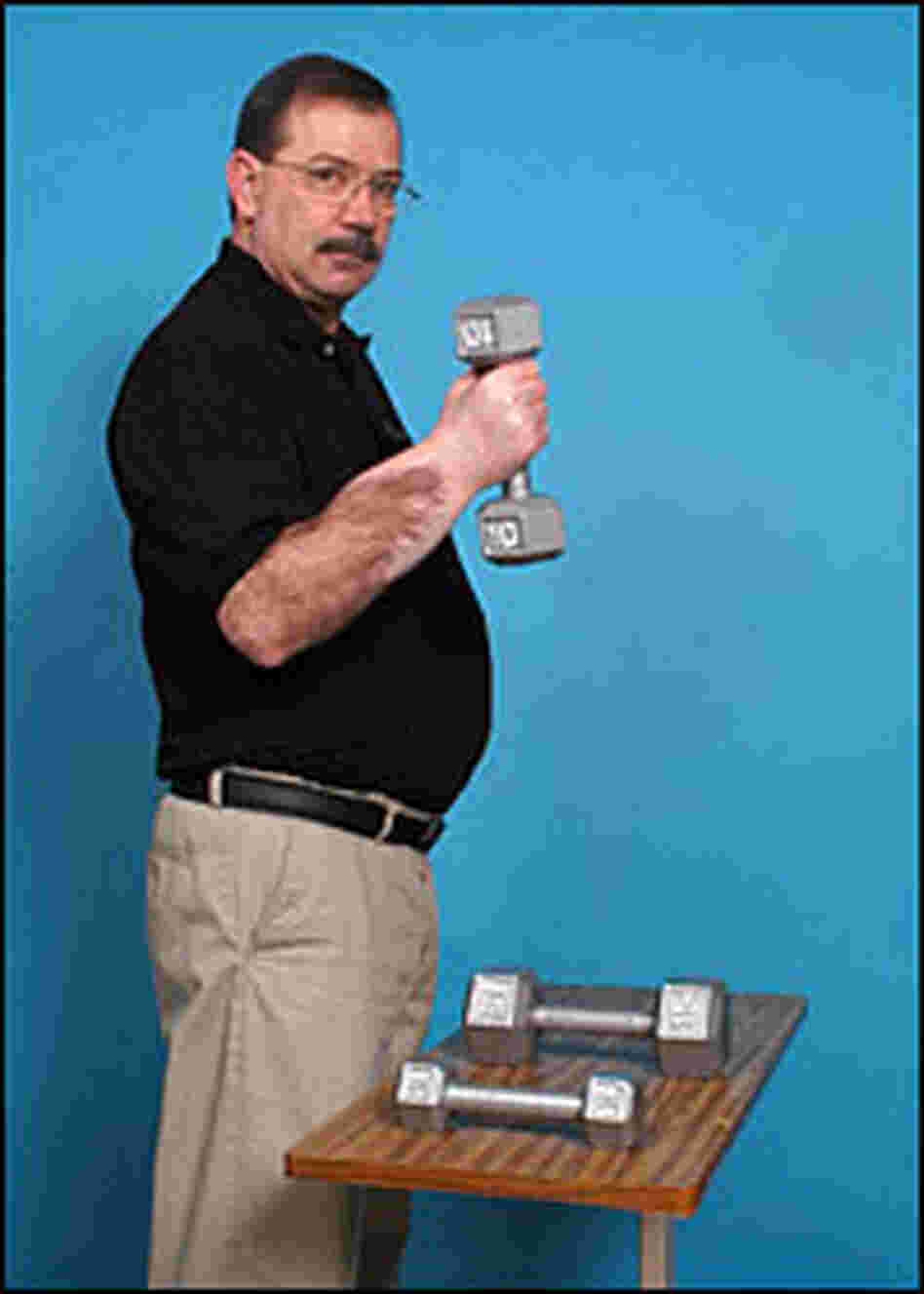 Transplant patient David Savage holds a weight.