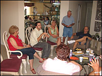 Taylor Magenheim, in white shirt, talks with his grandparents and their friends about why he supports Barack Obama.