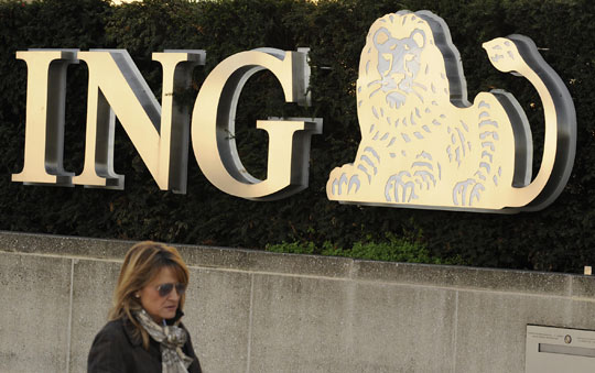 A woman walks in front of a Brussels branch of the banking giant ING.