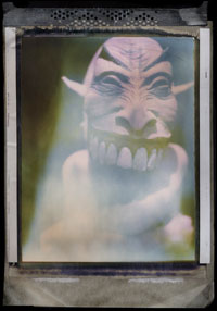 A pinkish alien with big white teeth.