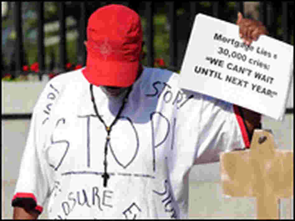 Deborah Williams holds a sign and a homemade key