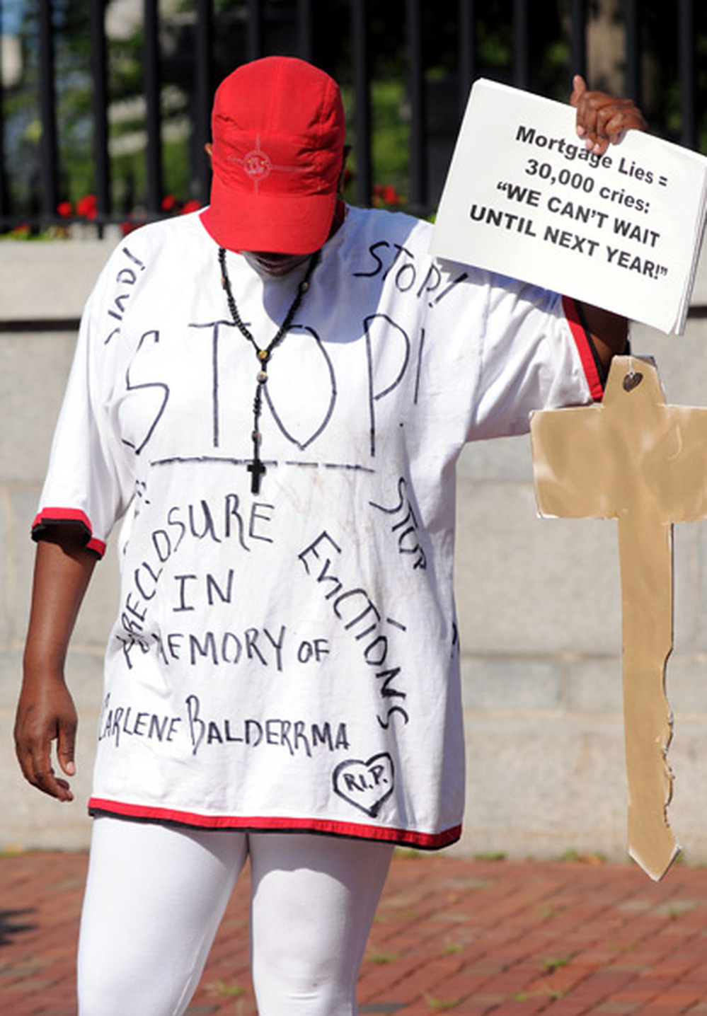 Deborah Williams holds a sign and a homemade key