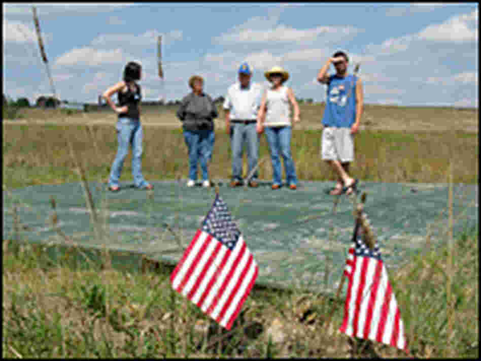 Borza stands with Jack Strong and his family on the spot where the plane crashed.
