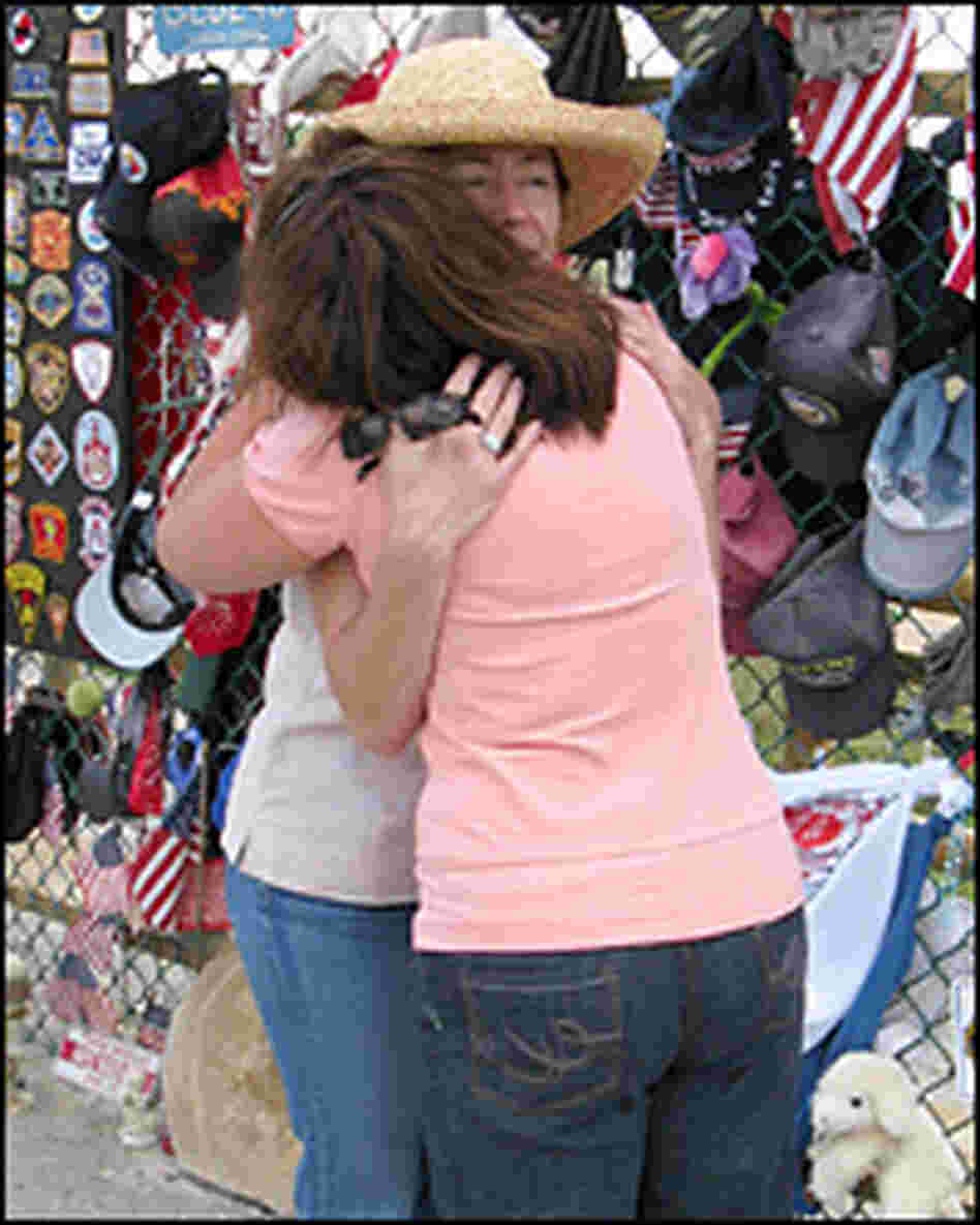 Deborah Borza (left) hugs a visitor at the temporary memorial for Flight 93 in Shanksville, Pa.