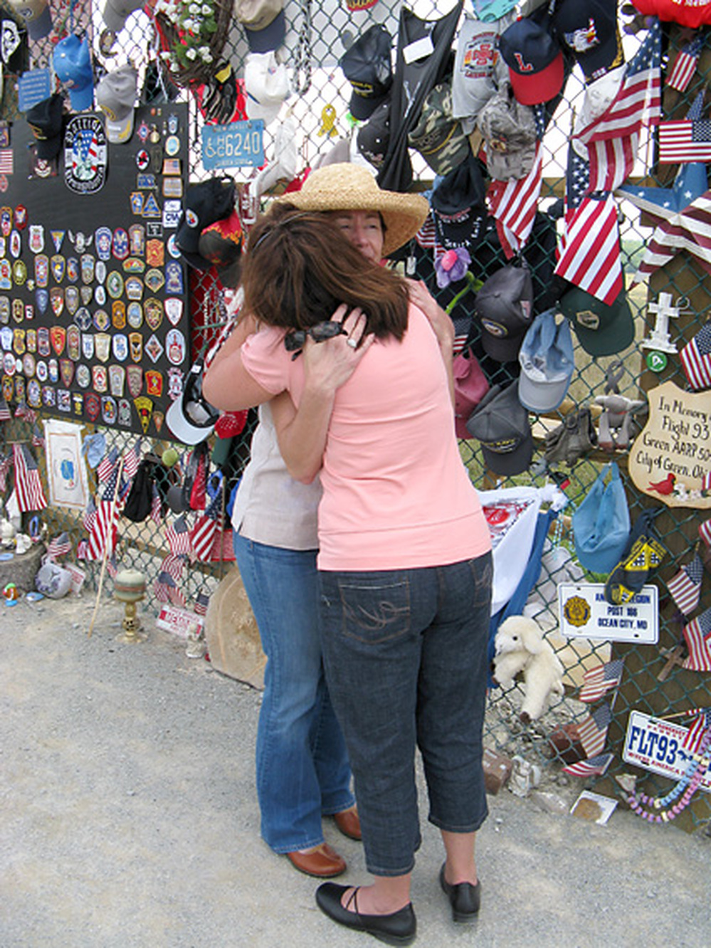 Deborah Borza (left) hugs a visitor at the temporary memorial for Flight 93 in Shanksville, Pa.