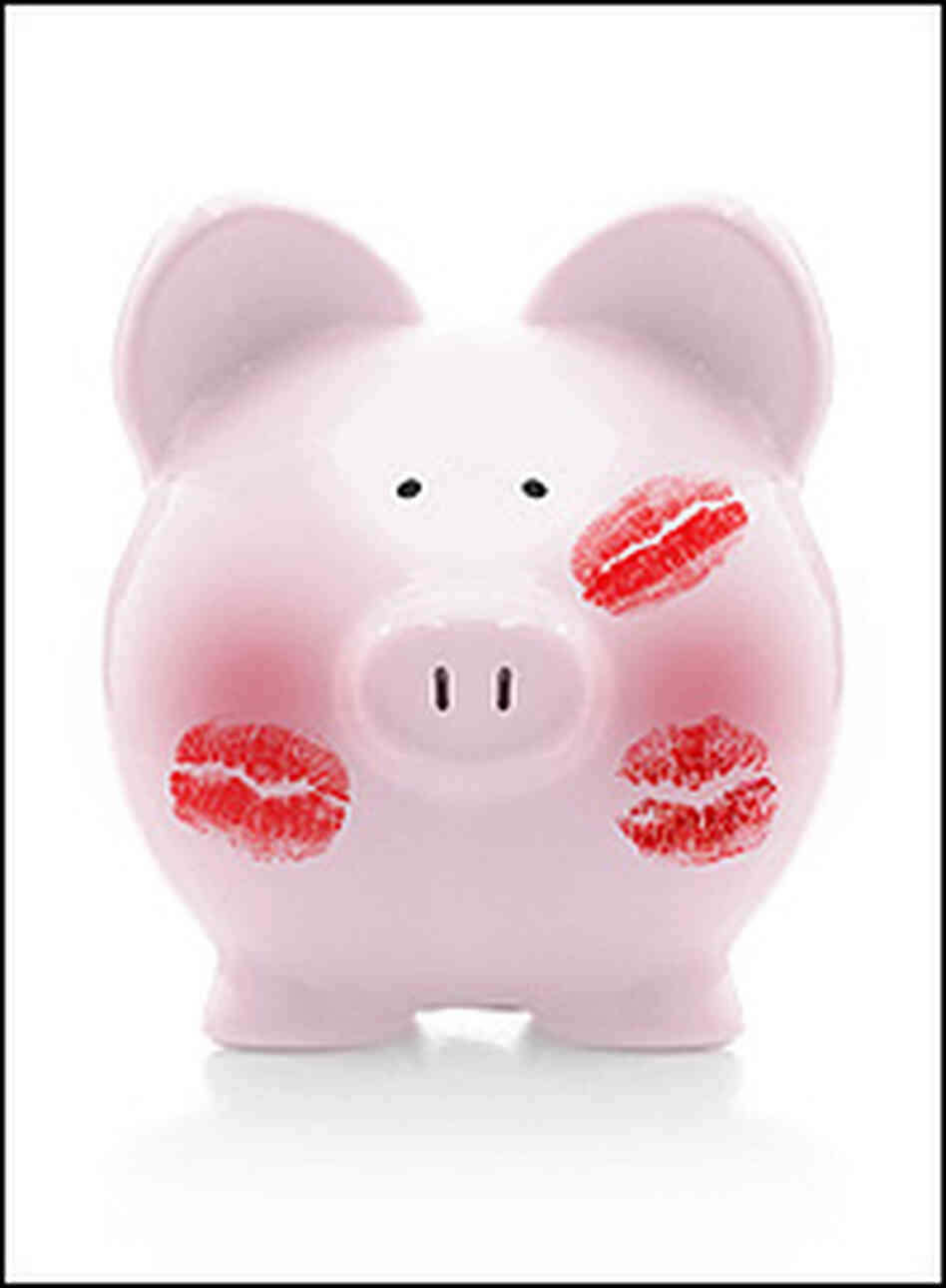 A pink piggy bank is covered with lipstick smears. A pink piggy bank is covered with lipstick smears.