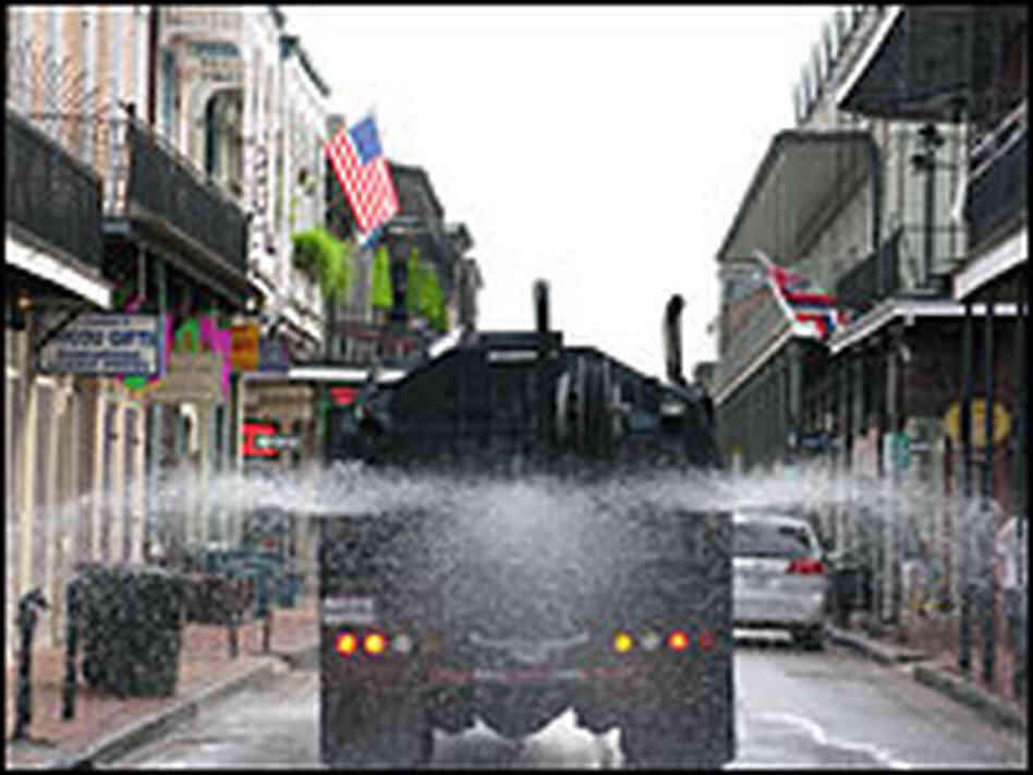 A truck sprays Superfresh onto the streets of New Orleans' French Quarter.