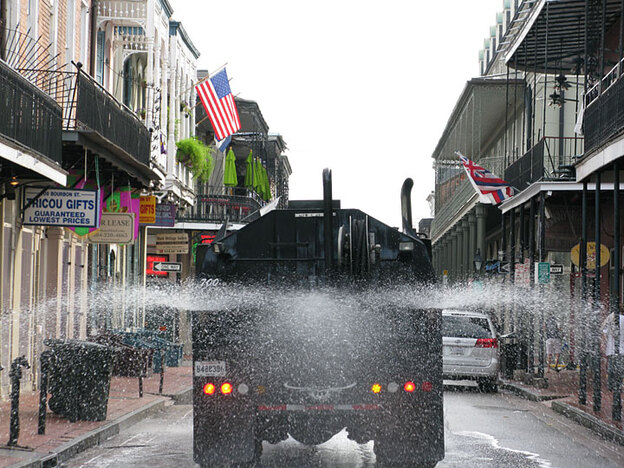 A truck sprays Superfresh onto the streets of New Orleans' French Quarter.