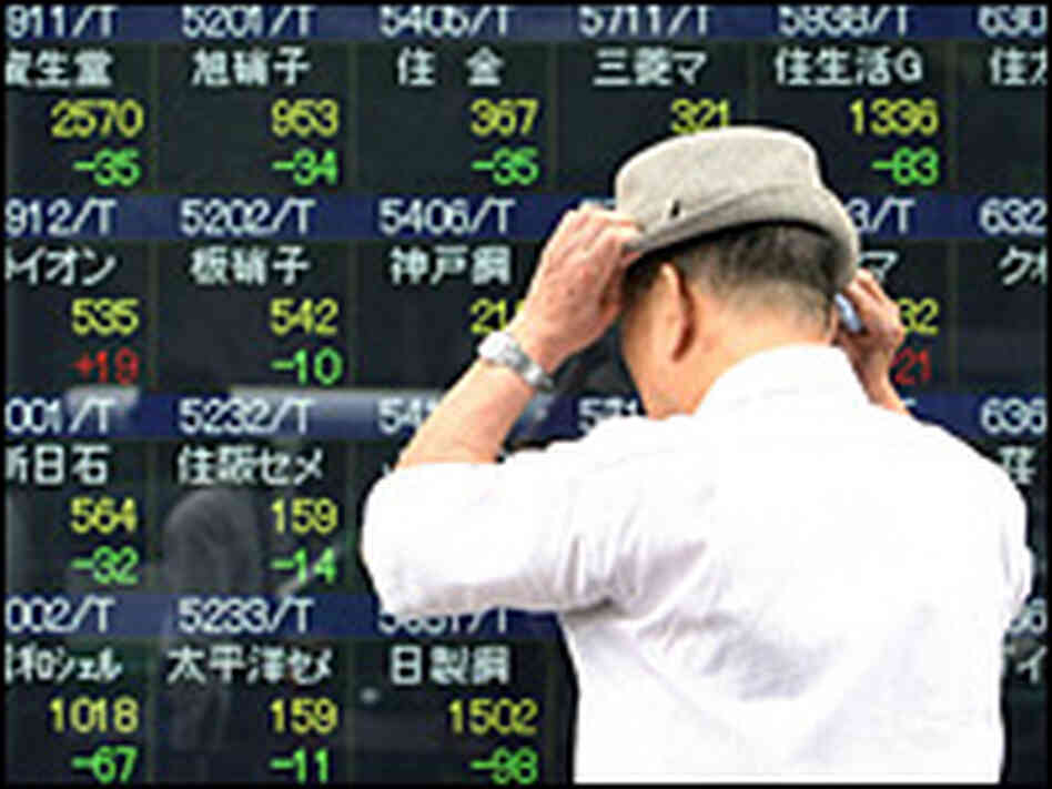A man looks at an electronic display board showing falling share prices in Tokyo on Tuesday.