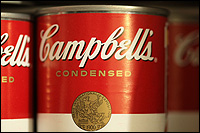 A closeup shot of the familiar red-and-white label of Campbell's Soup.
