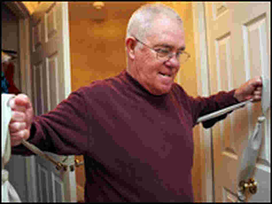 Stoodley demonstrates a stretch with an elastic band.