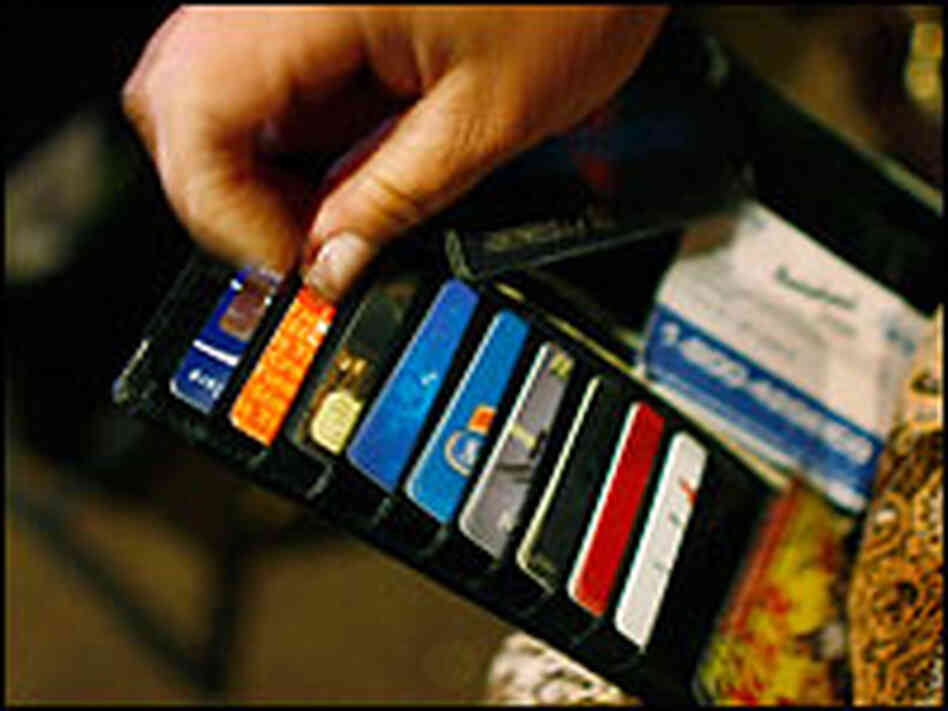 Ileana Garcia looks at credit cards in her wallet.