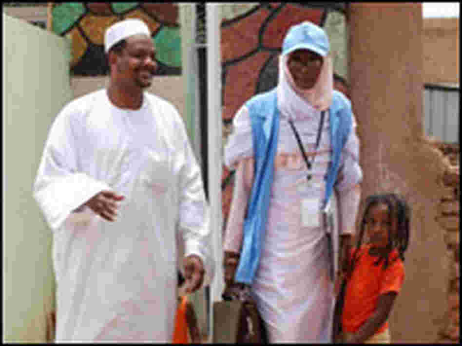 A census-taker talks to a family in Sudan