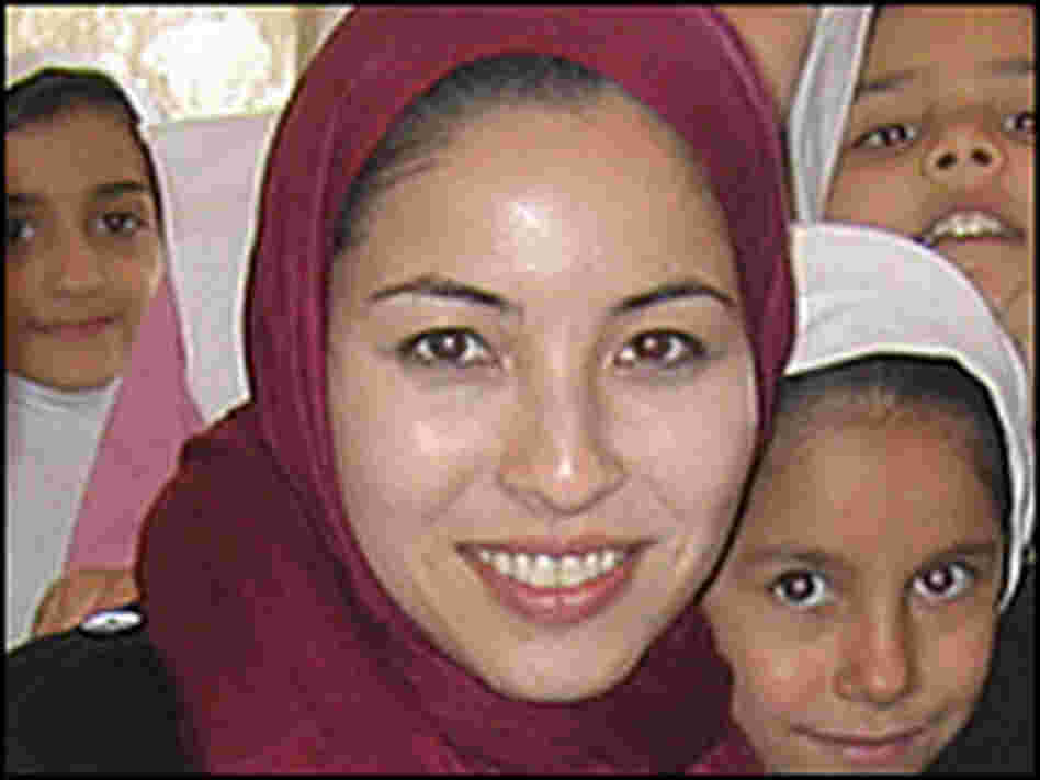 In this photo taken before her arrest, Roxana Saberi poses with schoolchildren in Iran.
