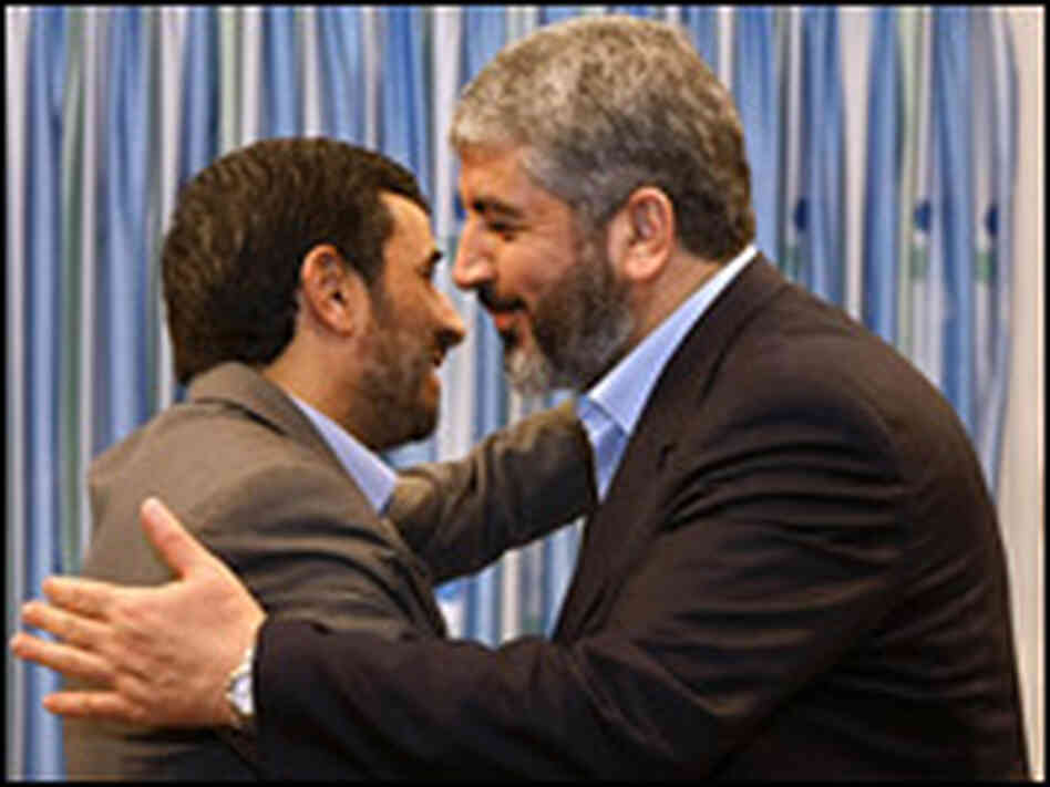 Mahmoud Ahmadinejad embraces Hamas political leader Khaled Meshaal.