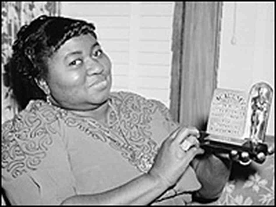 Actress Hattie McDaniel with her Oscar plaque.