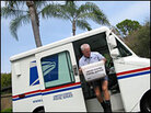 Mail carrier Mark Sinnen steps out of his mail truck with a bucket of mail. Mail carrier Mark Sinnen steps out of his mail truck with a bucket of mail.