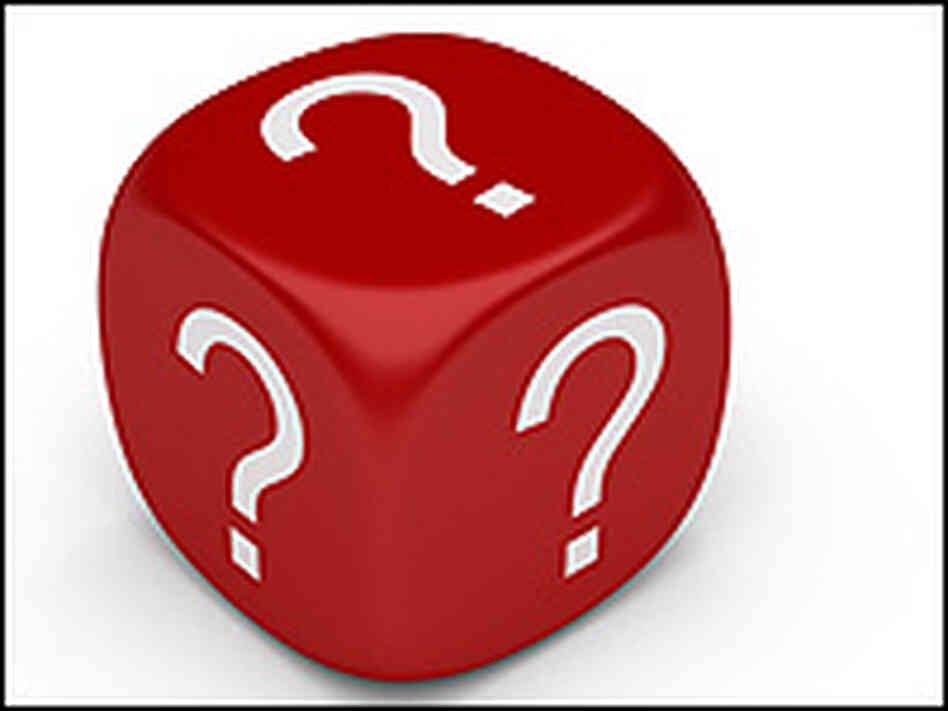 A red dice cube is covered with white question marks. A red dice cube is covered with white question marks.
