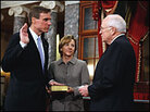 Sen. Mark Warner stands with his wife and Vice President Dick Cheney during a mock swearing-in. Sen. Mark Warner stands with his wife and Vice President Dick Cheney during a mock swearing-in.