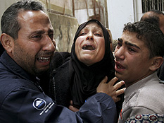 Palestinian relatives of a father and four of his sons from the Khalout family who were killed in an Israeli army operation, react in the family house during their funeral in Beit Lahiya in the northern Gaza Strip, Thursday, Jan. 8, 2009. Credit: Khalil Hamra/AP