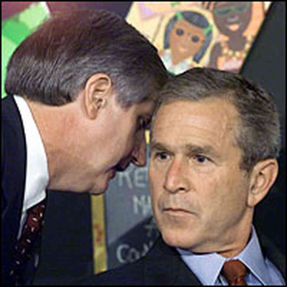 President Bush's chief of staff whispers to him at a school reading event Sept. 11, 2001, in Florida