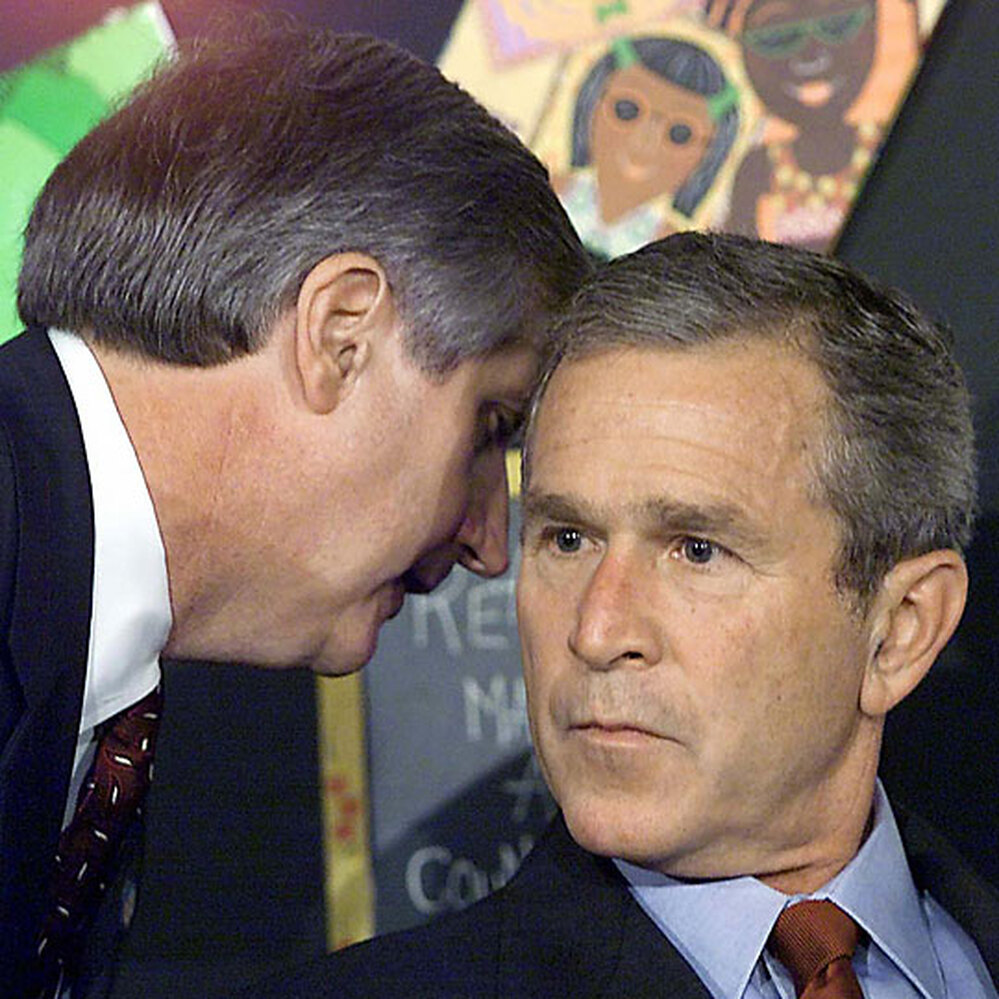 President Bush's chief of staff whispers to him at a school reading event Sept. 11, 2001, in Florida