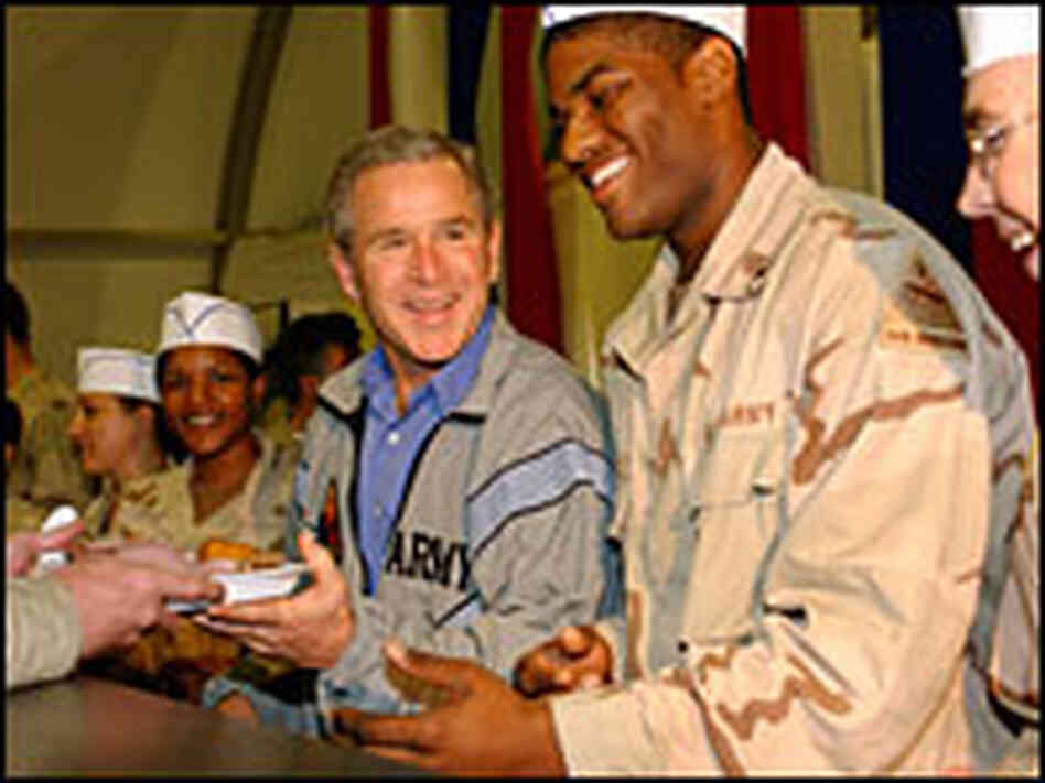 President Bush delivers food to U.S. troops during a surprise Thanksgiving visit to Baghdad in 2003