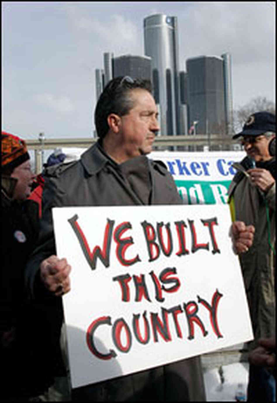 An autoworker pickets Sunday outside the auto show at Detroit's Cobo Center.