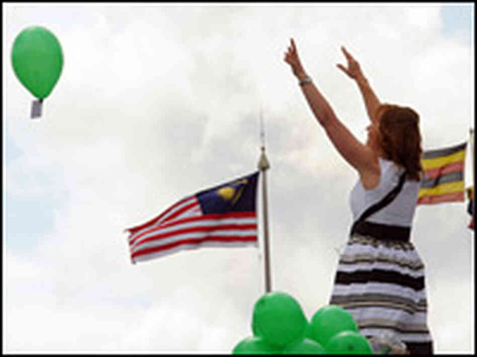 Jill Gatcum releases balloons as she occupies the empty fourth plinth in Trafalgar Square.