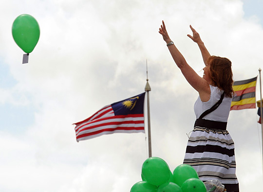 Jill Gatcum releases balloons as she occupies the empty fourth plinth in Trafalgar Square.