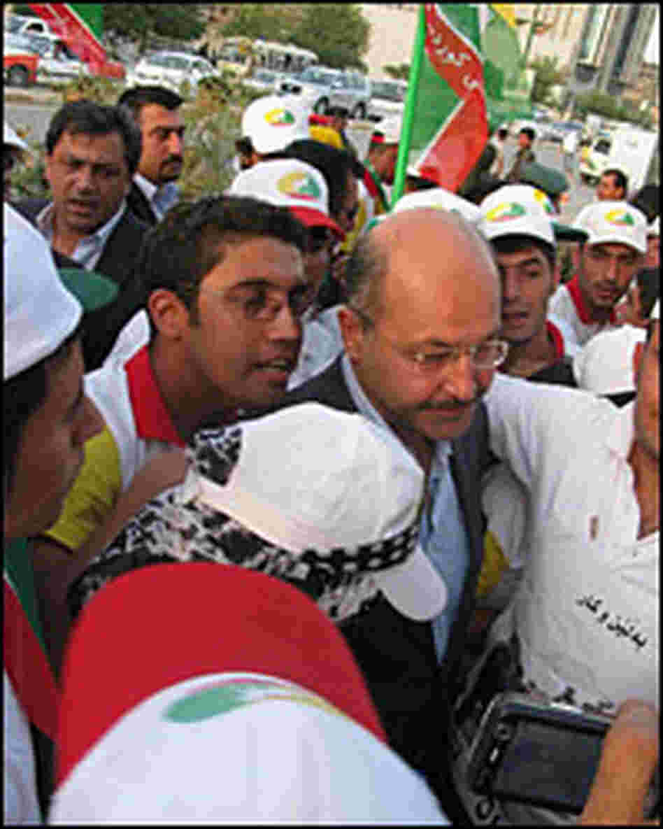 Barham Salih is surrounded by supporters at a rally in Sulimaniya