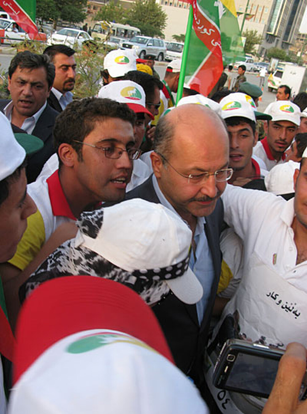 Barham Salih is surrounded by supporters at a rally in Sulimaniya
