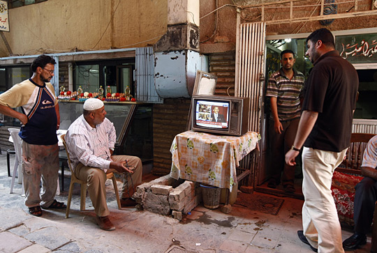 Iraqi men in Baghdad watch a live broadcast on satellite TV of President Obama's speech in Cairo