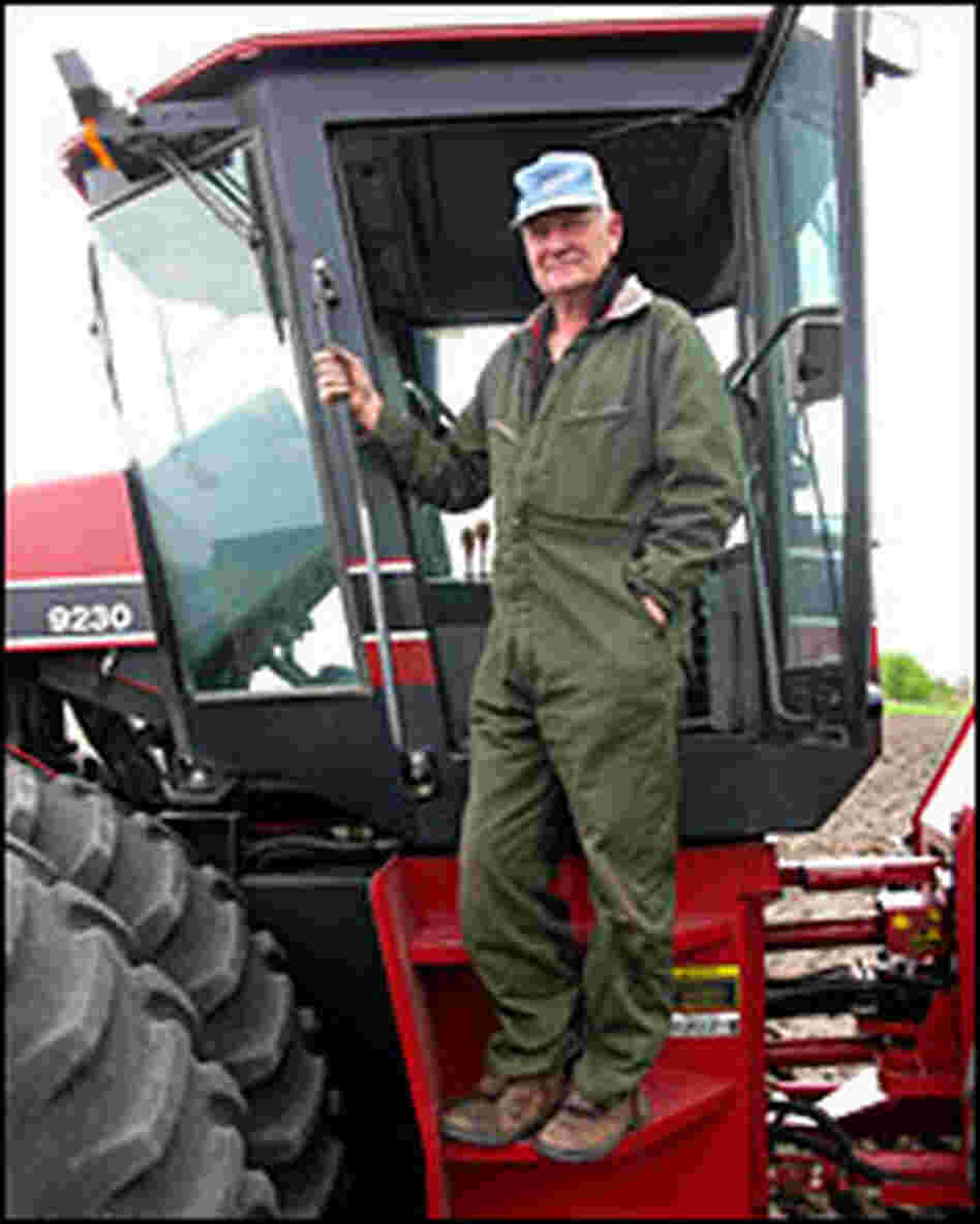 Farmer Linus Solberg climbs into his cultivator in Cylinder, Iowa
