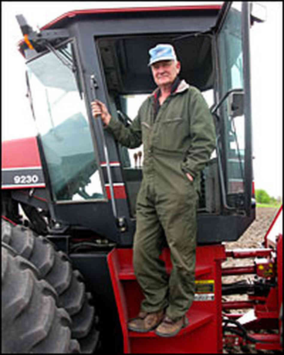 Farmer Linus Solberg climbs into his cultivator in Cylinder, Iowa