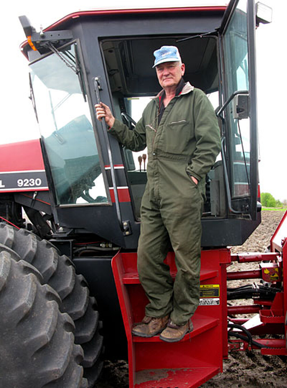 Farmer Linus Solberg climbs into his cultivator in Cylinder, Iowa