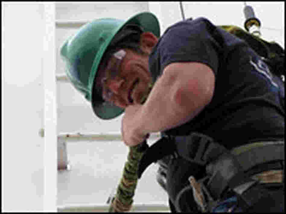 Quentin Johnson climbing a wind turbine