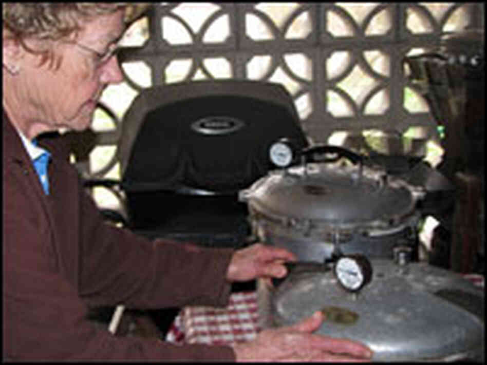 Pat Summer of Springfield, Mo., inspects her "canners," which are large pressure cookers.