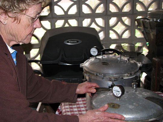 Pat Summer of Springfield, Mo., inspects her "canners," which are large pressure cookers.