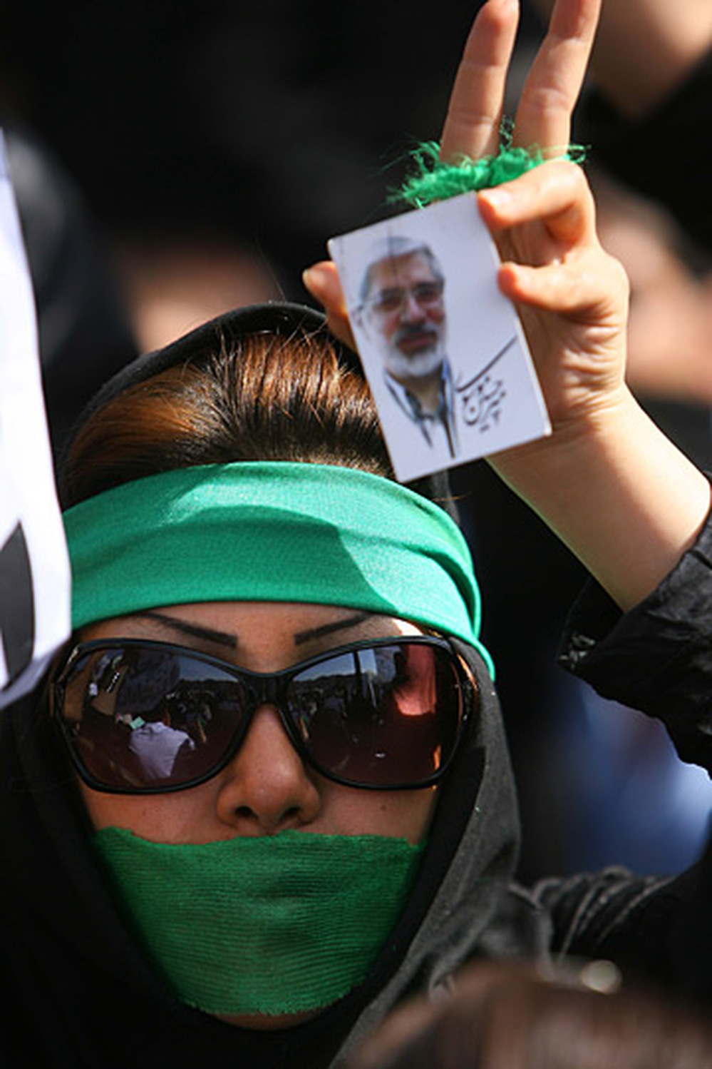A supporter of opposition leader Mir Hossein Mousavi listens to his speech in Tehran on Thursday.