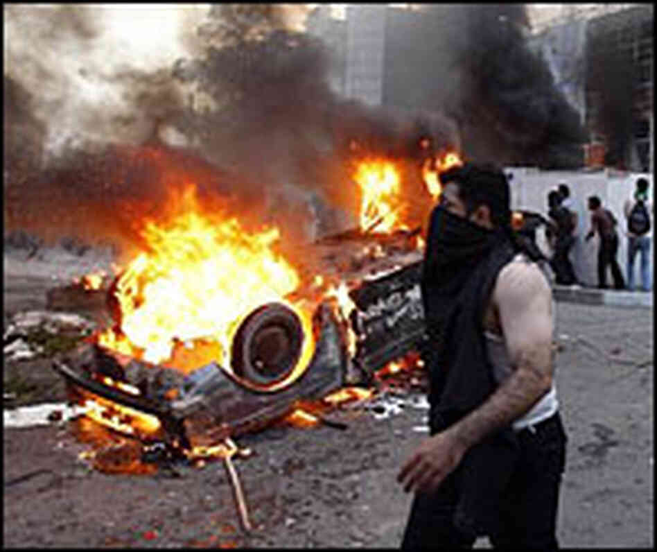 A car burns during protests in Iran.