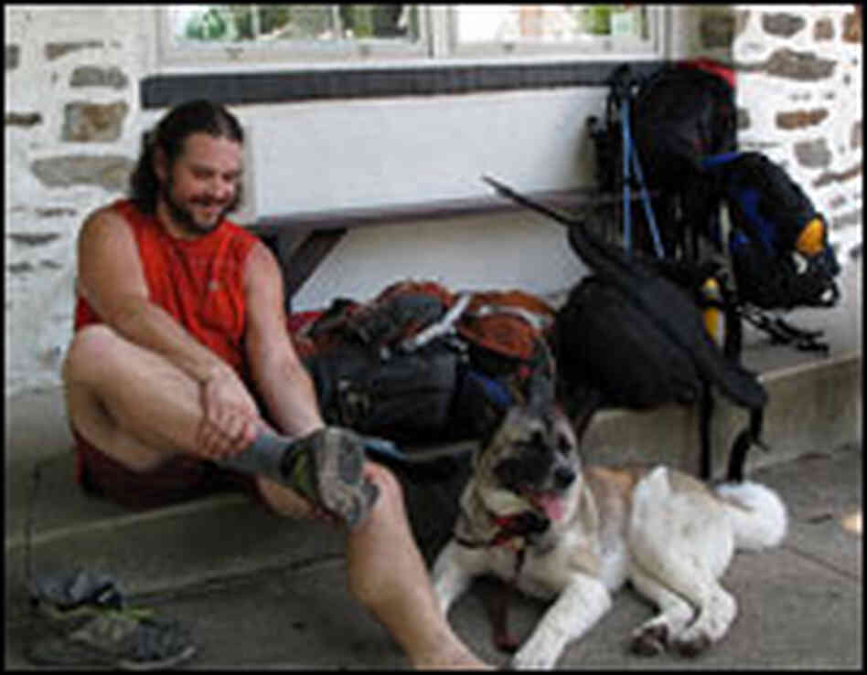 Chris Lee and his dog rest in front of the Appalachian Trail Headquarters in Harper's Ferry, Va. Chris Lee and his dog rest in front of the Appalachian Trail Headquarters in Harper's Ferry, Va.