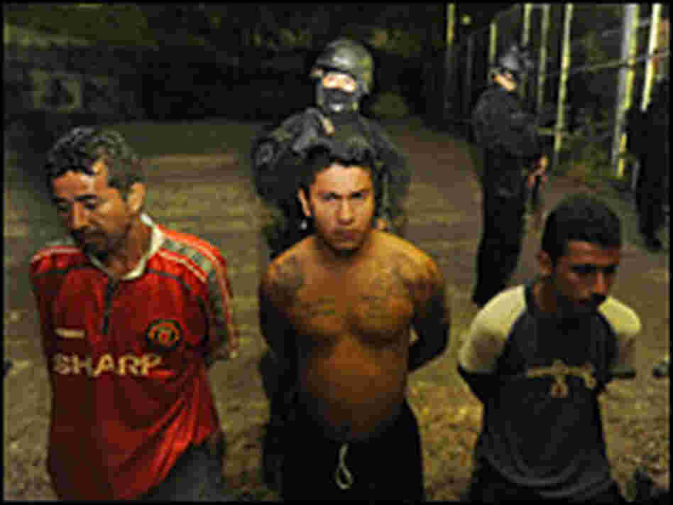 Members of El Salvador's National Civil Police guard suspected members of the notorious gang 18