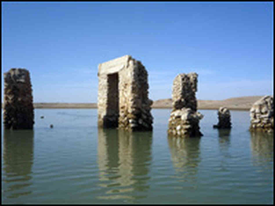 Ancient buildings have emerged from the river bed as the Euphrates dries up.